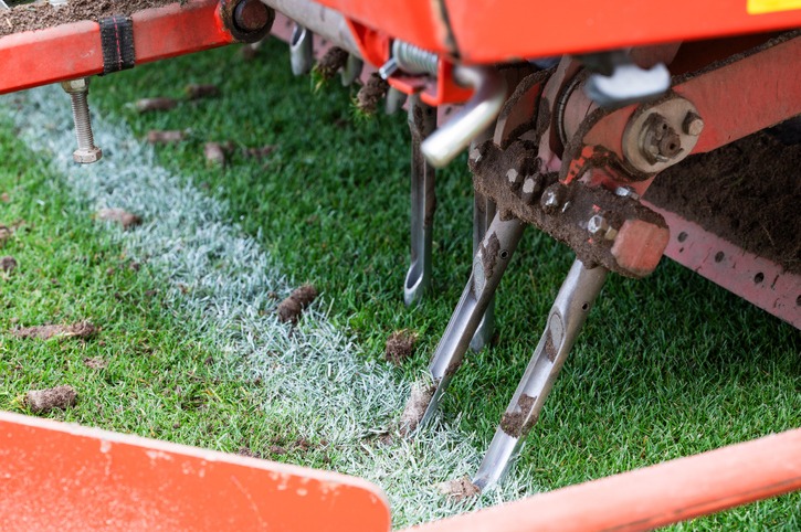 Detail of aeration machine during grasslands football field