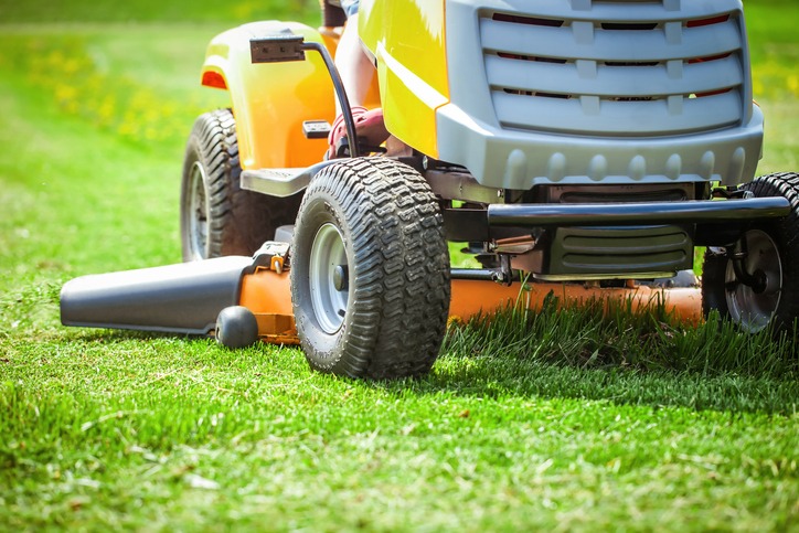 Closeup of mower cutting the grass